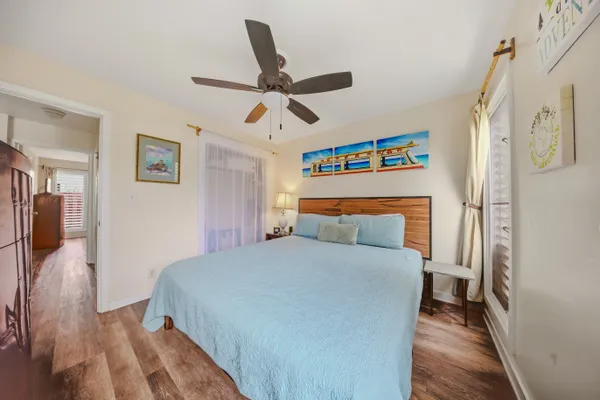 a bedroom with a bed and a ceiling fan