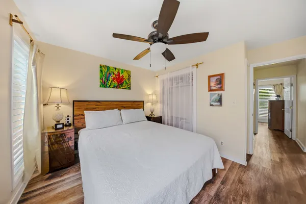a bedroom with a large bed and a chandelier