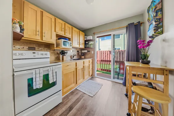 a open kitchen with stainless steel appliances granite countertop a stove a sink and a refrigerator