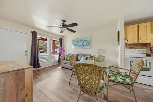 a living room with furniture a large window with wooden floor