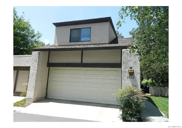 a side view of a house with a garage