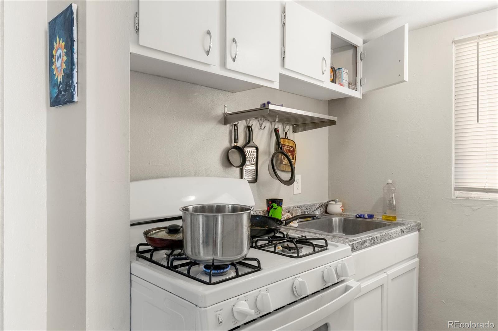 1558 Dallas Street Aurora, CO 80010 - Photo 13 of 24 a kitchen with a stove and cabinets