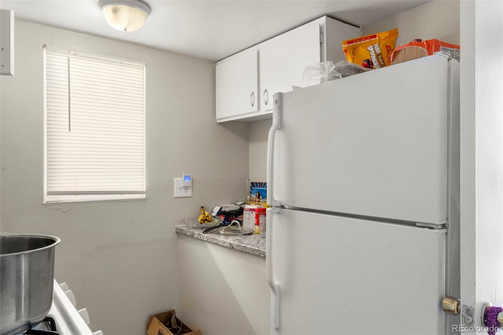 1558 Dallas Street Aurora, CO 80010 - Photo 14 of 24 a white refrigerator freezer sitting inside of a kitchen