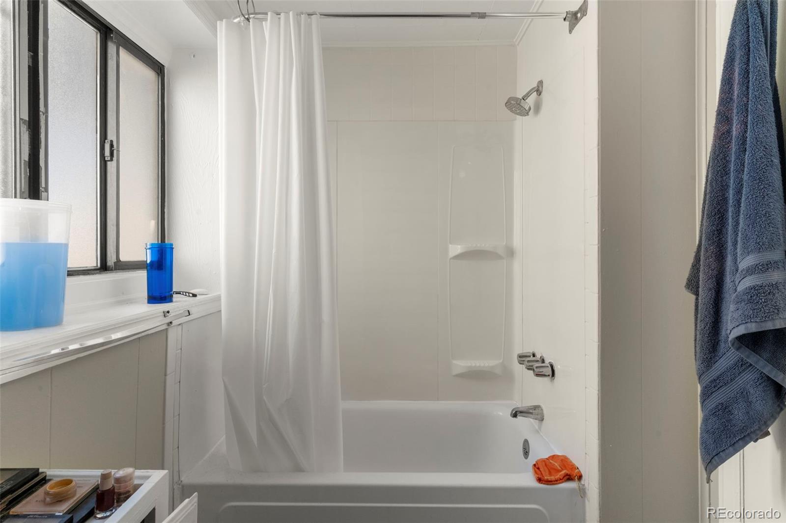 1558 Dallas Street Aurora, CO 80010 - Photo 16 of 24 a bathroom with a bathtub and a shower