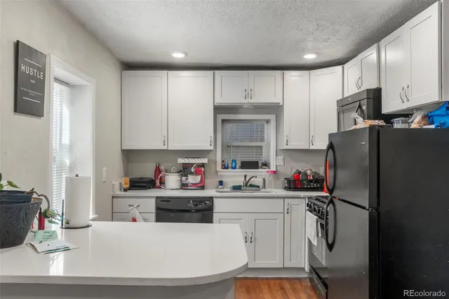 a kitchen with stainless steel appliances a sink dishwasher stove microwave and refrigerator