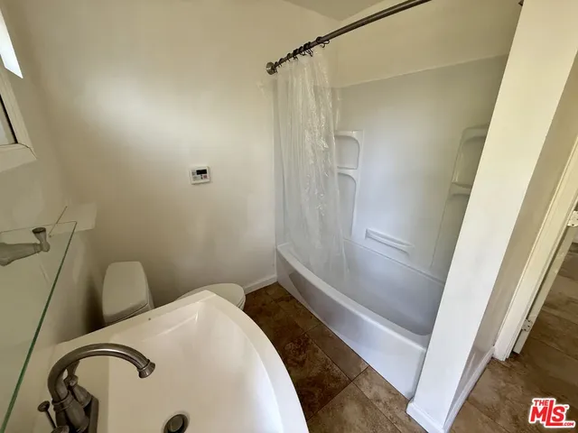 a bathroom with a sink and shower
