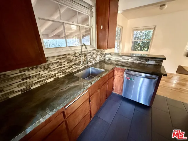 a kitchen with a sink stove and wooden cabinets