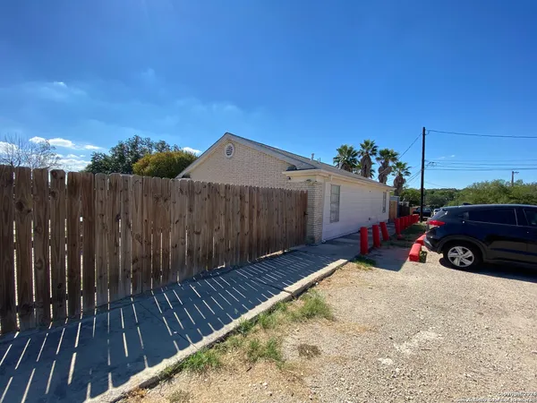 a view of a house with wooden fence