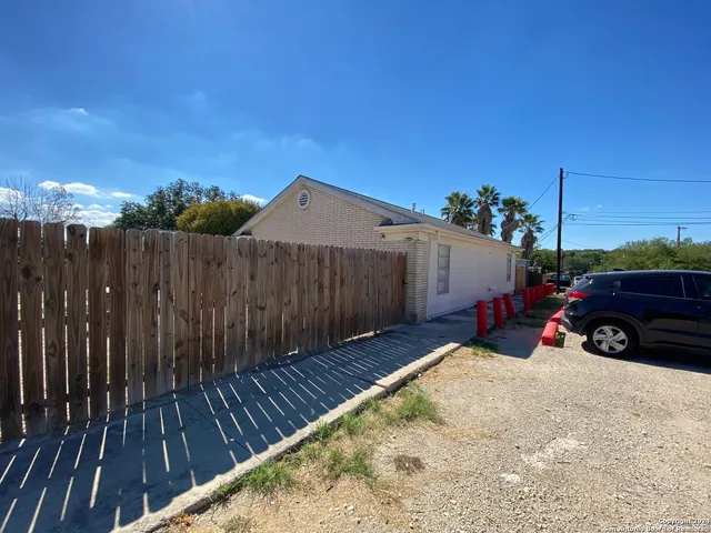 a view of a house with wooden fence