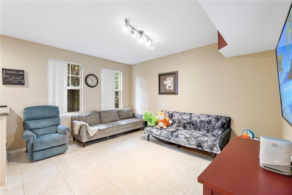 6926 West Sample Road, Unit 6926 Coral Springs, FL 33067 - Photo 13 of 41 a living room with furniture and a couch