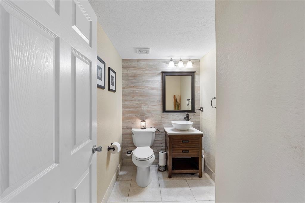 6926 West Sample Road, Unit 6926 Coral Springs, FL 33067 - Photo 15 of 41 a bathroom with a toilet a sink and a mirror