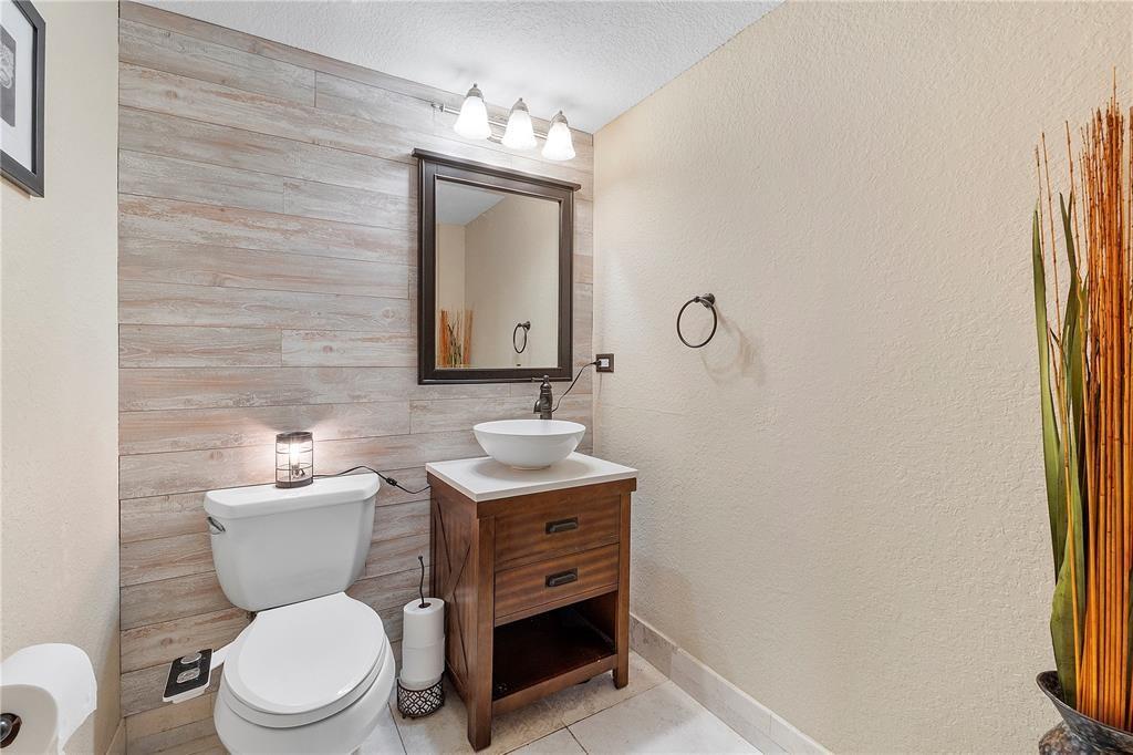 6926 West Sample Road, Unit 6926 Coral Springs, FL 33067 - Photo 16 of 41 a bathroom with a toilet a sink and mirror