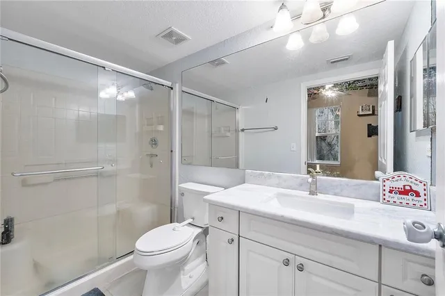 a bedroom with a bed window and a chandelier