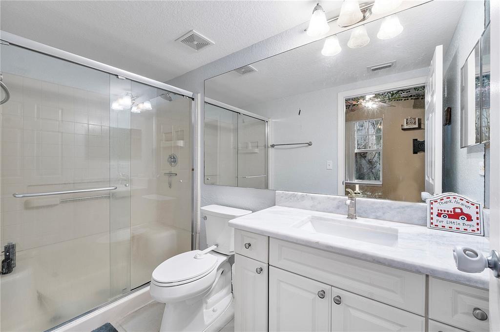 6926 West Sample Road, Unit 6926 Coral Springs, FL 33067 - Photo 19 of 41 a bathroom with a sink a toilet and shower