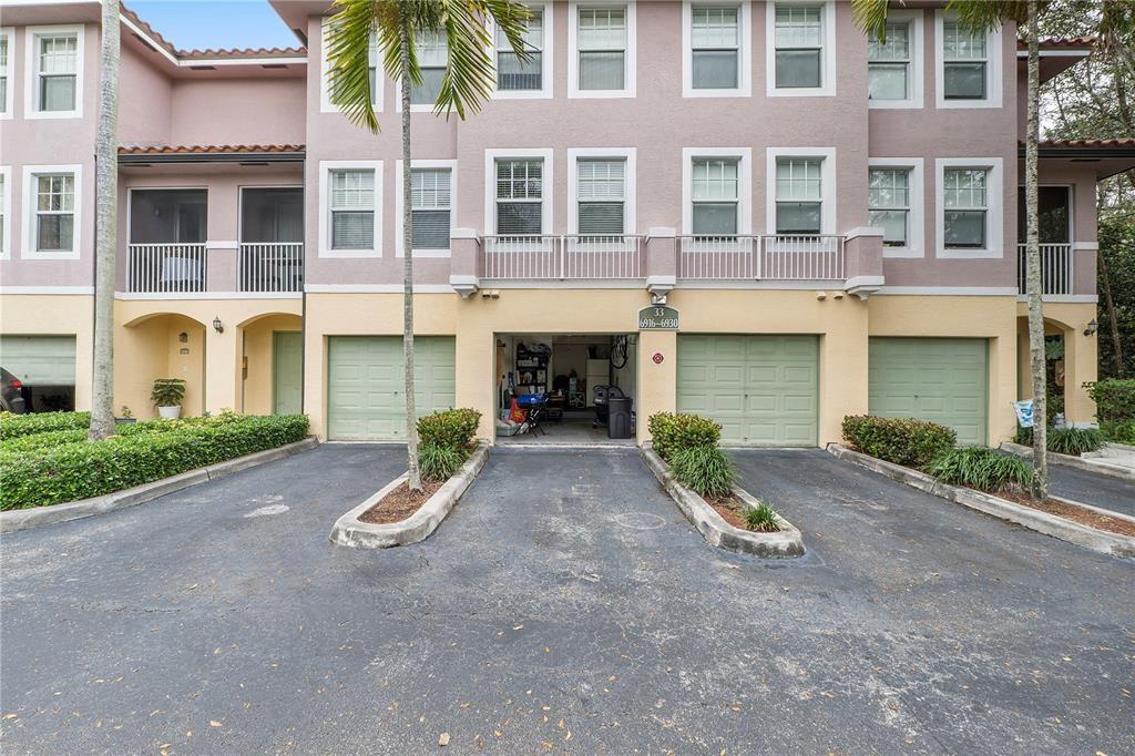6926 West Sample Road, Unit 6926 Coral Springs, FL 33067 - Photo 26 of 41 front view of a building with a yard and a garage