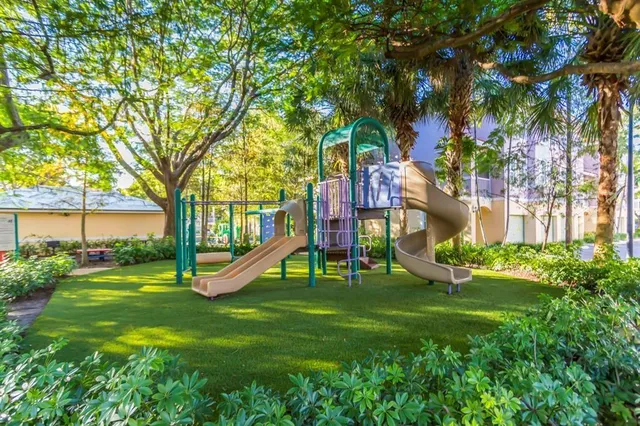 a view of a fountain in the yard with potted plants