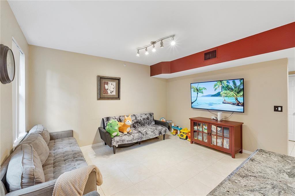 6926 West Sample Road, Unit 6926 Coral Springs, FL 33067 - Photo 5 of 41 a bedroom with furniture and a couch