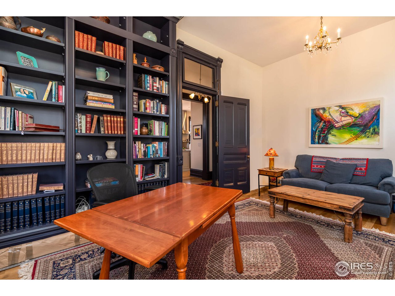 1507 Pine Street Boulder, CO 80302 - Photo 13 of 28 a room with bookshelf table and book shelf