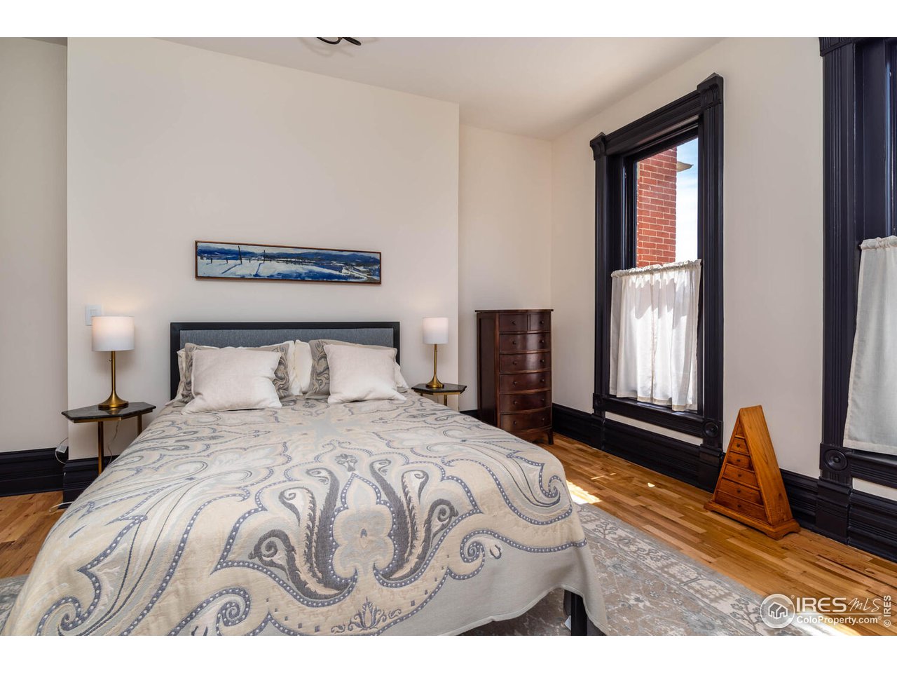 1507 Pine Street Boulder, CO 80302 - Photo 19 of 28 a bedroom with a bed wooden floor and window