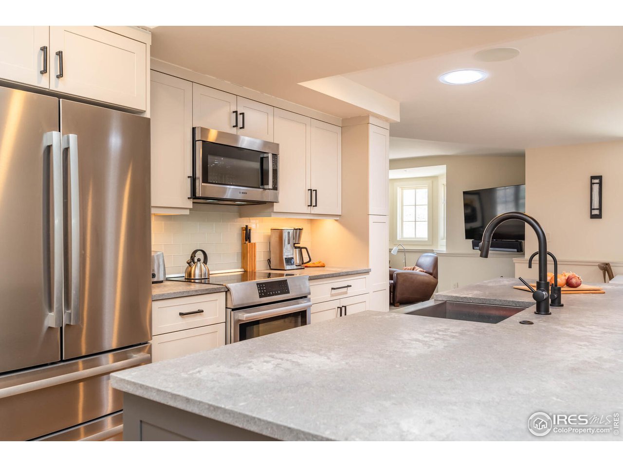 1507 Pine Street Boulder, CO 80302 - Photo 23 of 28 a kitchen with refrigerator a microwave and wooden floor