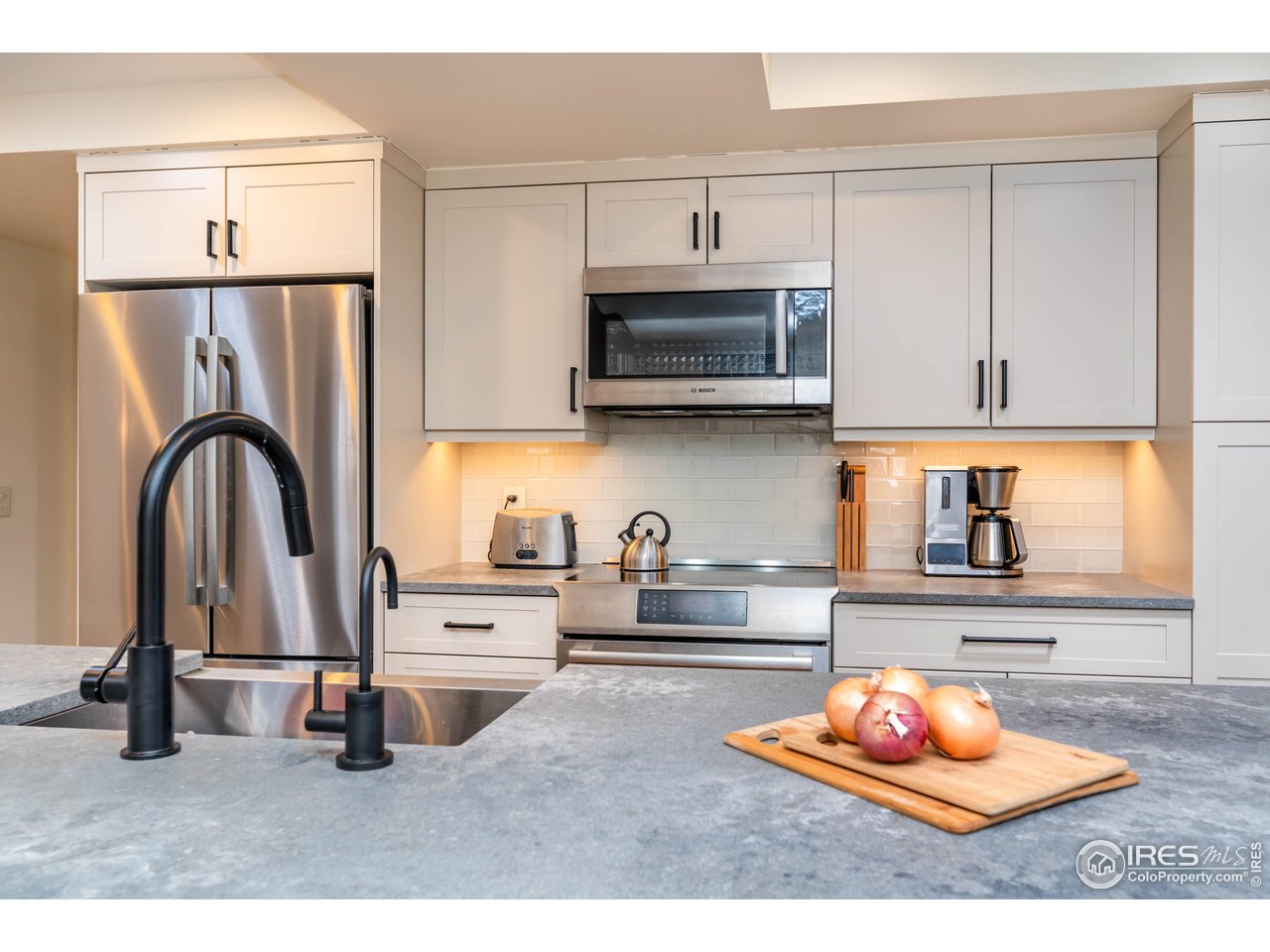 1507 Pine Street Boulder, CO 80302 - Photo 24 of 28 a kitchen with stainless steel appliances granite countertop a refrigerator sink and cabinets