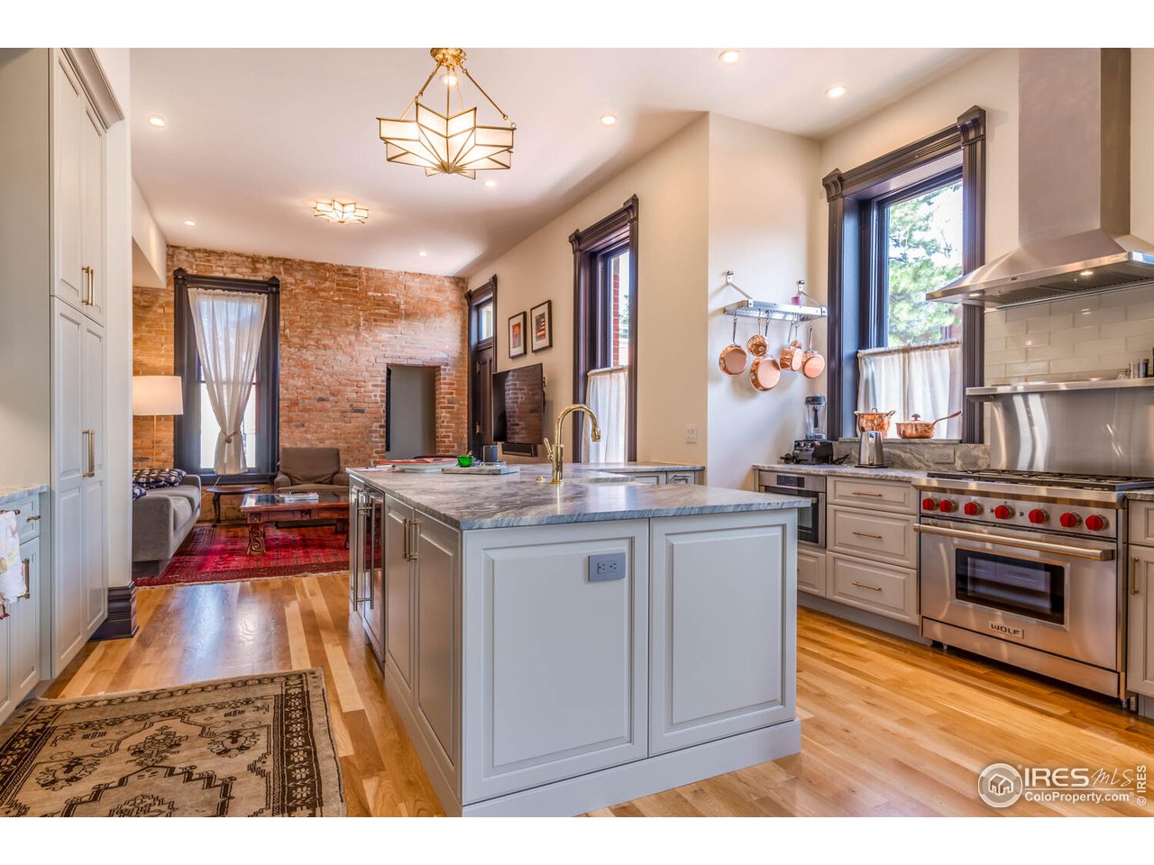 1507 Pine Street Boulder, CO 80302 - Photo 8 of 28 a kitchen with kitchen island granite countertop a stove and a sink