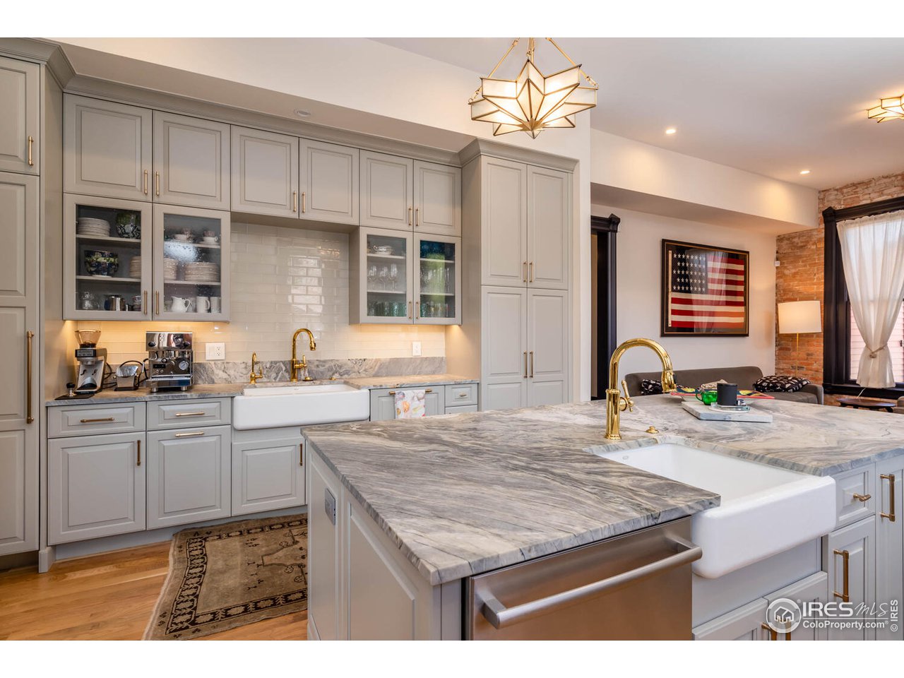 1507 Pine Street Boulder, CO 80302 - Photo 10 of 28 a kitchen with kitchen island granite countertop a table chairs sink and cabinets