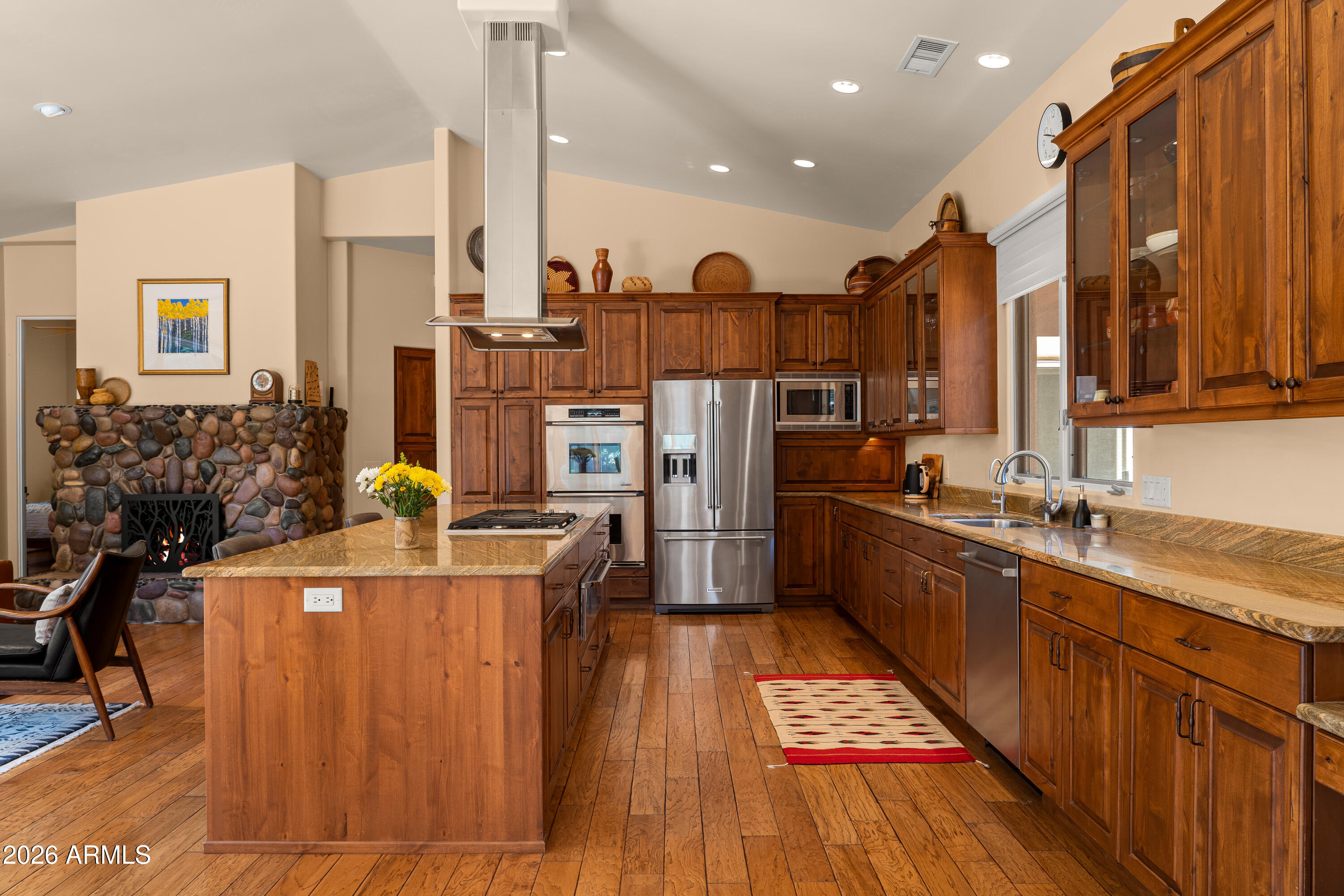 190 Morgan Road Sedona, AZ 86336 - Photo 32 of 51 a kitchen with stainless steel appliances kitchen island granite countertop a stove a sink dishwasher and a refrigerator with wooden floor