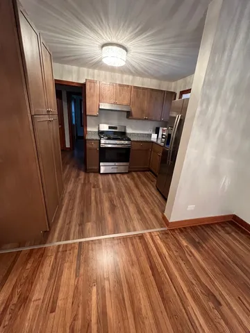 a view of kitchen with sink and refrigerator