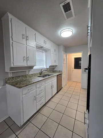 a kitchen with stainless steel appliances granite countertop a sink and cabinets