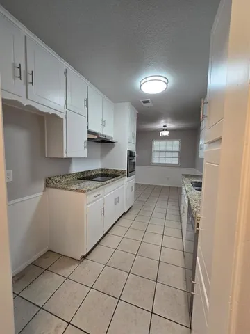 a kitchen with a cabinets and appliances