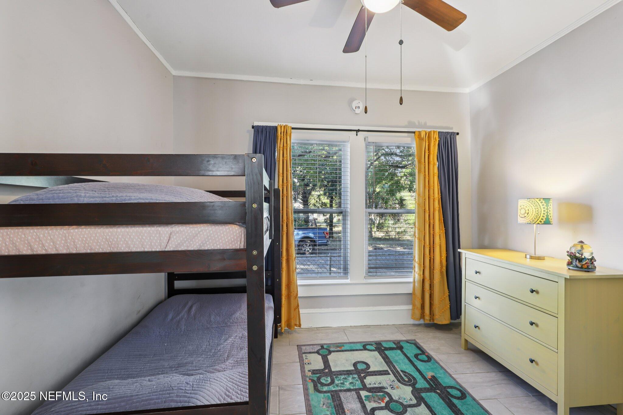 646 Day Avenue Jacksonville, FL 32205 - Photo 14 of 27 a view of a bedroom with wooden floor and windows