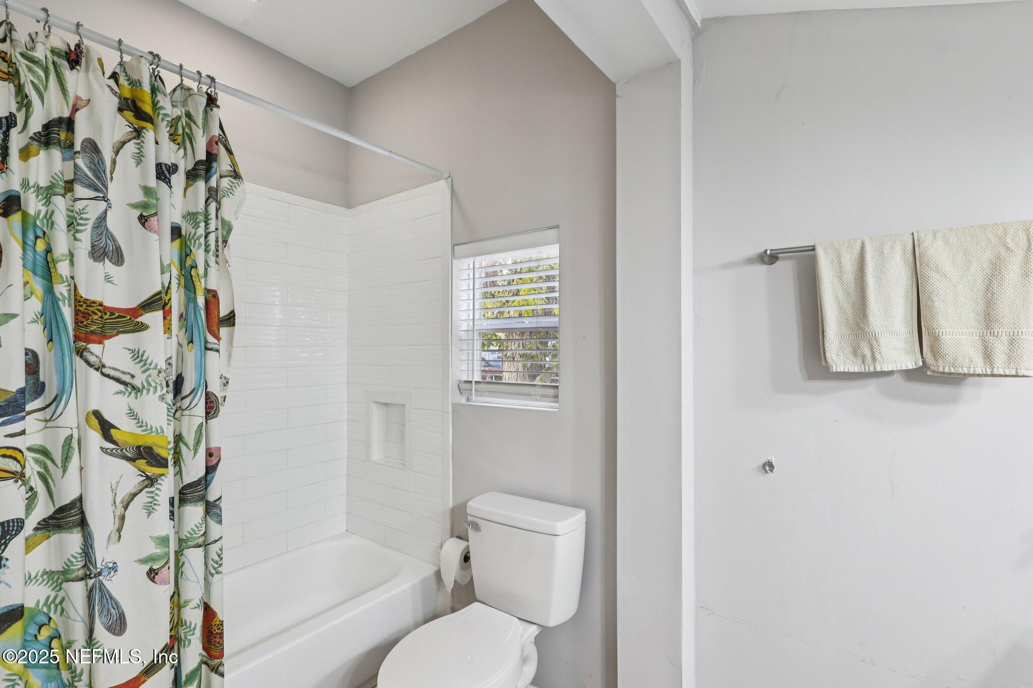 646 Day Avenue Jacksonville, FL 32205 - Photo 19 of 27 a bathroom with a toilet and a shower curtain