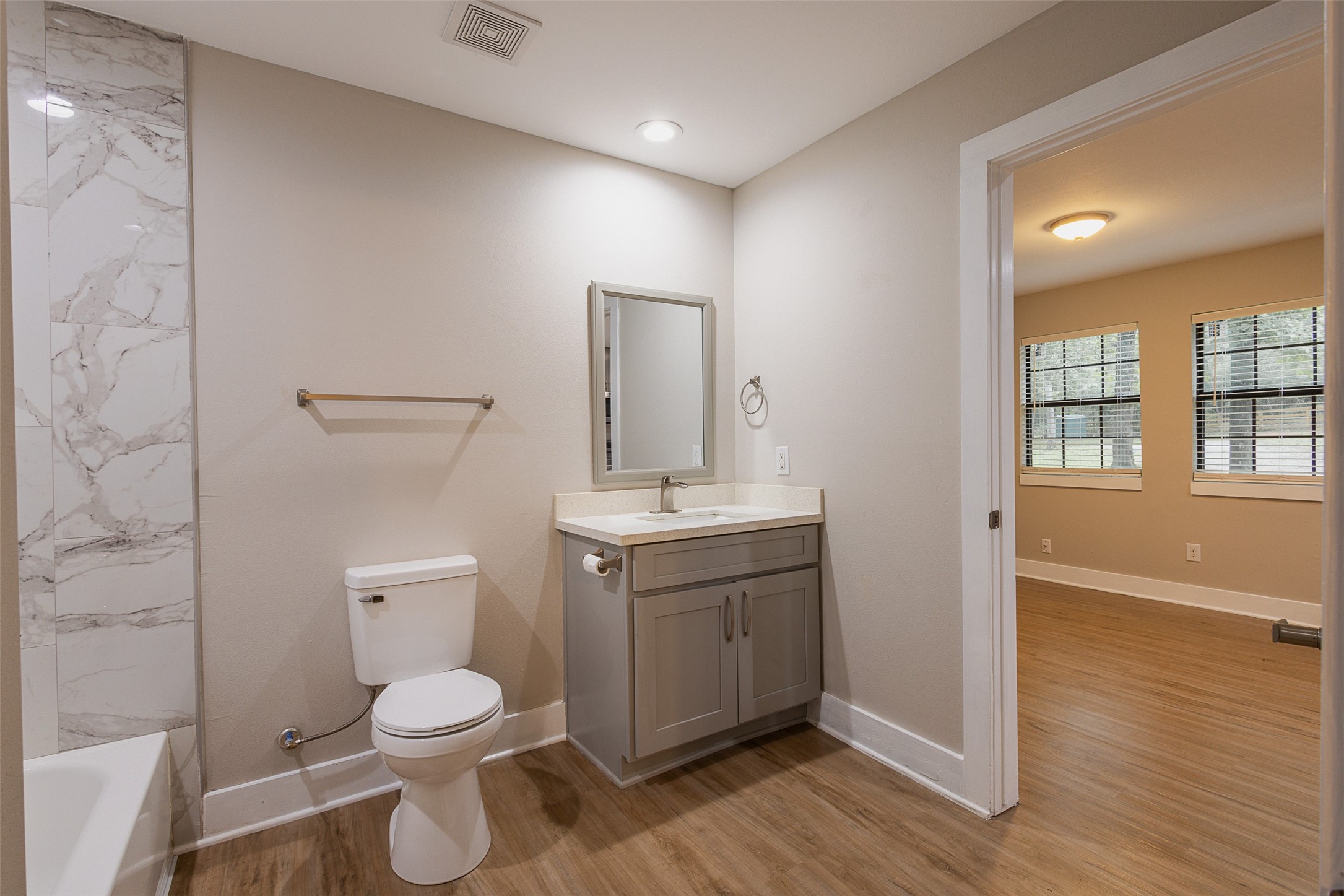 12028 Cedar Lane Conroe, TX 77303 - Photo 14 of 41 a bathroom with a toilet a sink and mirror