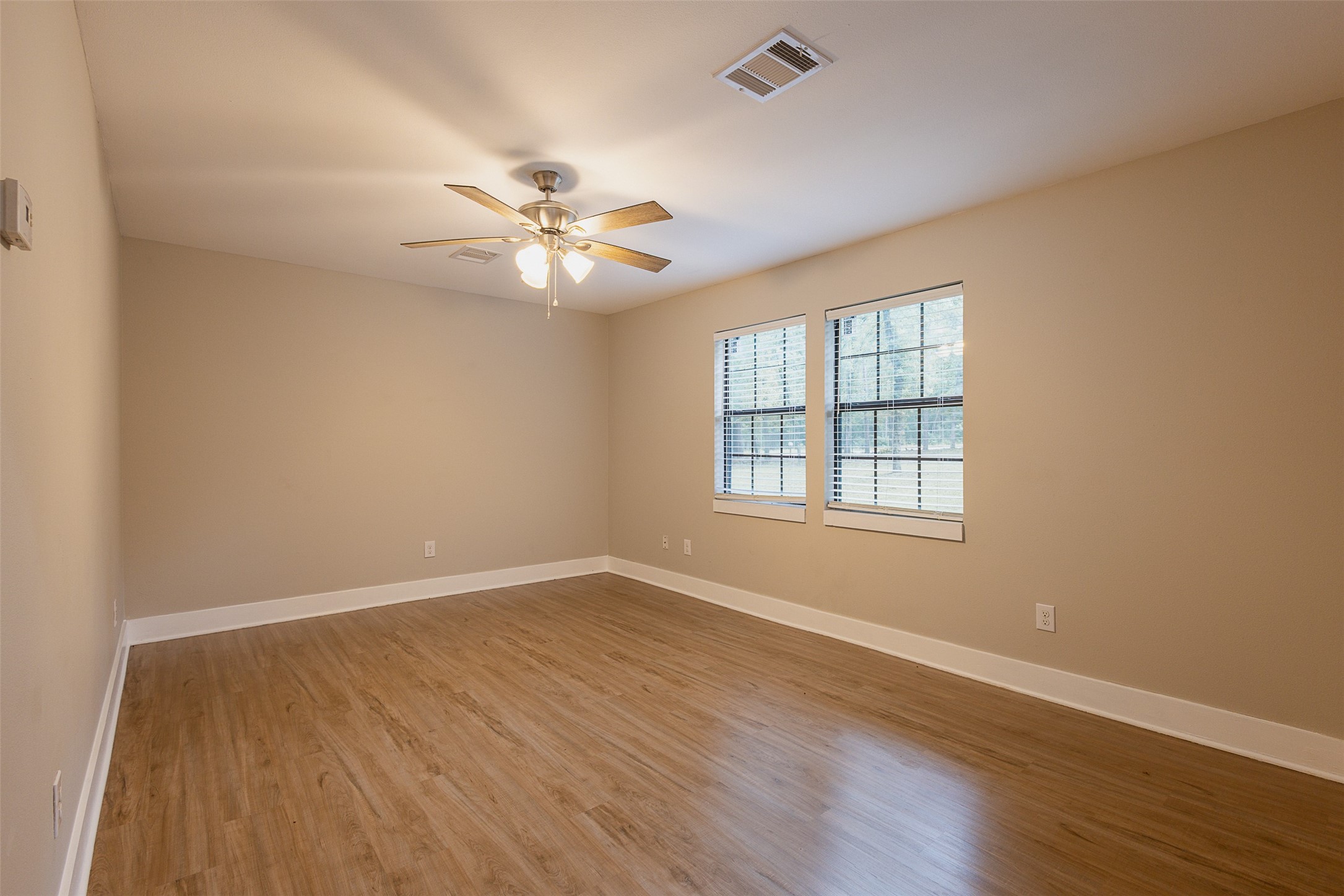 12028 Cedar Lane Conroe, TX 77303 - Photo 17 of 41 wooden floor in an empty room with a window