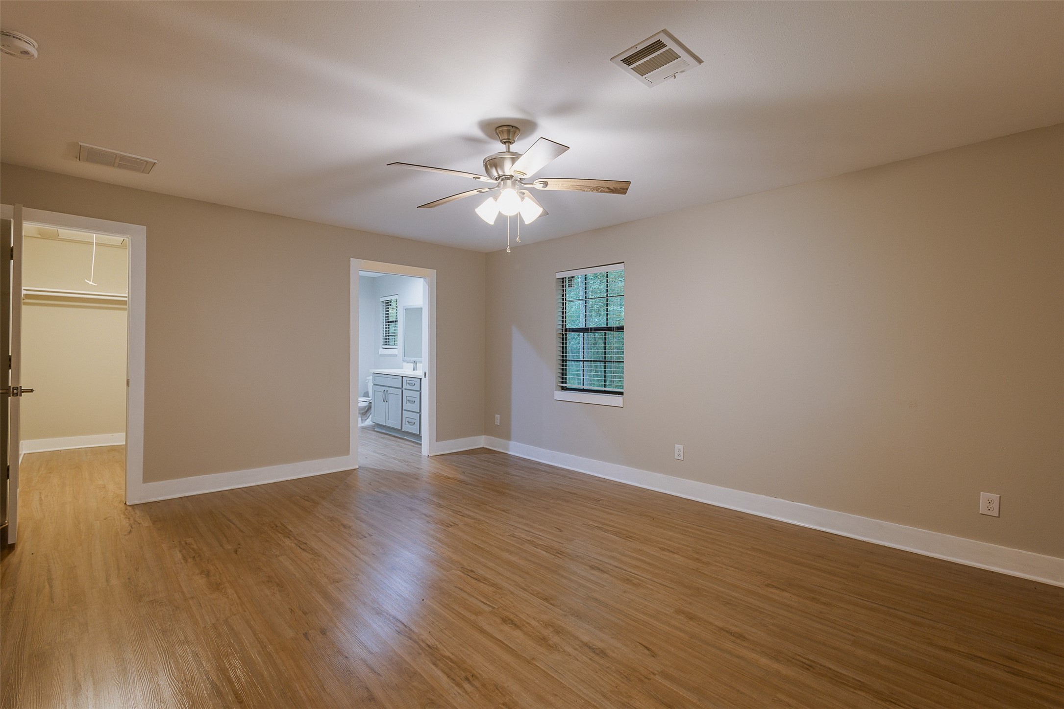 12028 Cedar Lane Conroe, TX 77303 - Photo 20 of 41 a view of an empty room with a window and wooden floor