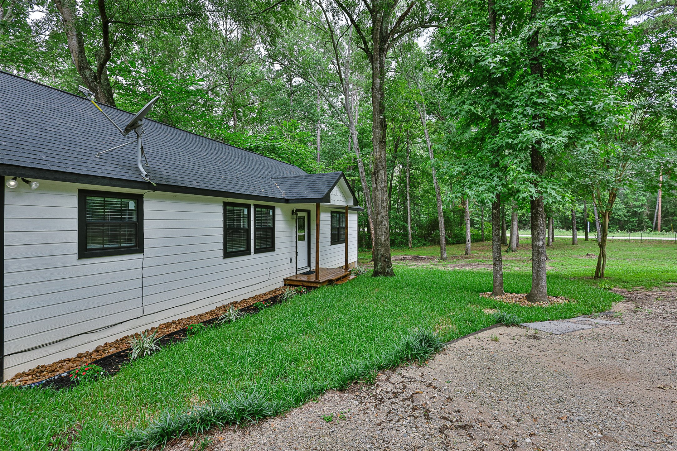 12028 Cedar Lane Conroe, TX 77303 - Photo 31 of 41 a view of a house with a backyard
