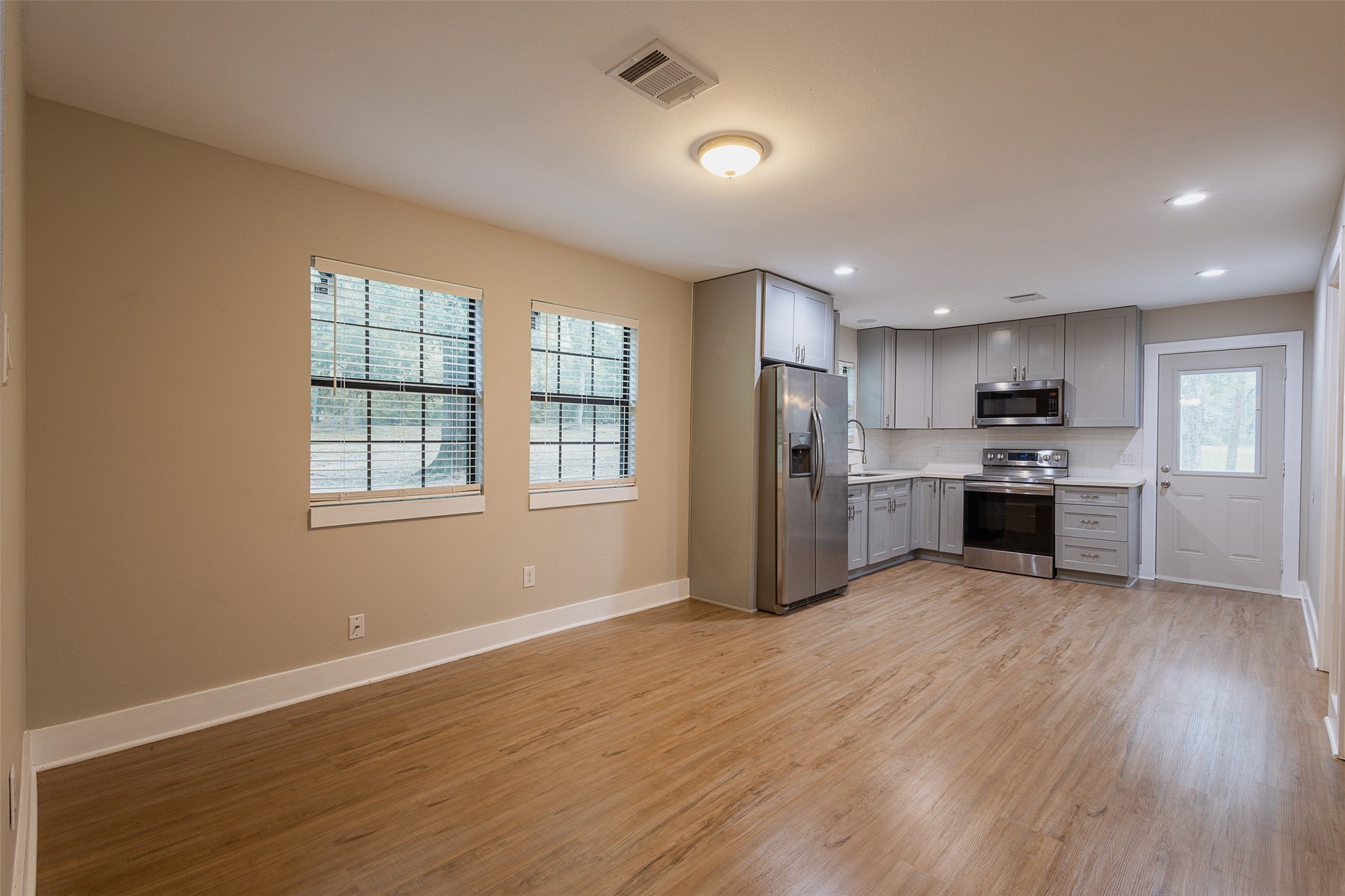 12028 Cedar Lane Conroe, TX 77303 - Photo 5 of 41 a view of kitchen with wooden floor and electronic appliances