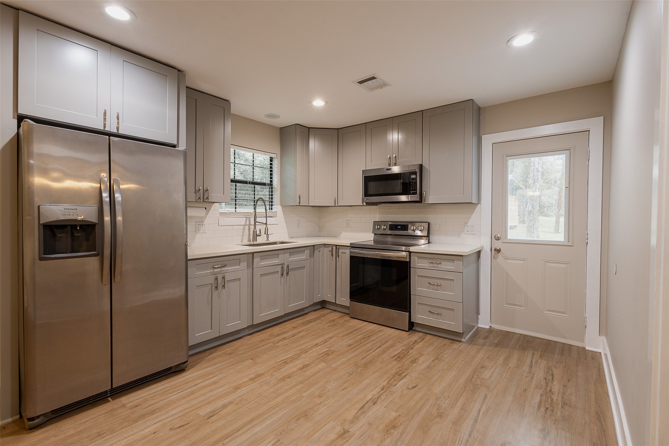 12028 Cedar Lane Conroe, TX 77303 - Photo 6 of 41 a kitchen with stainless steel appliances granite countertop a refrigerator sink and microwave