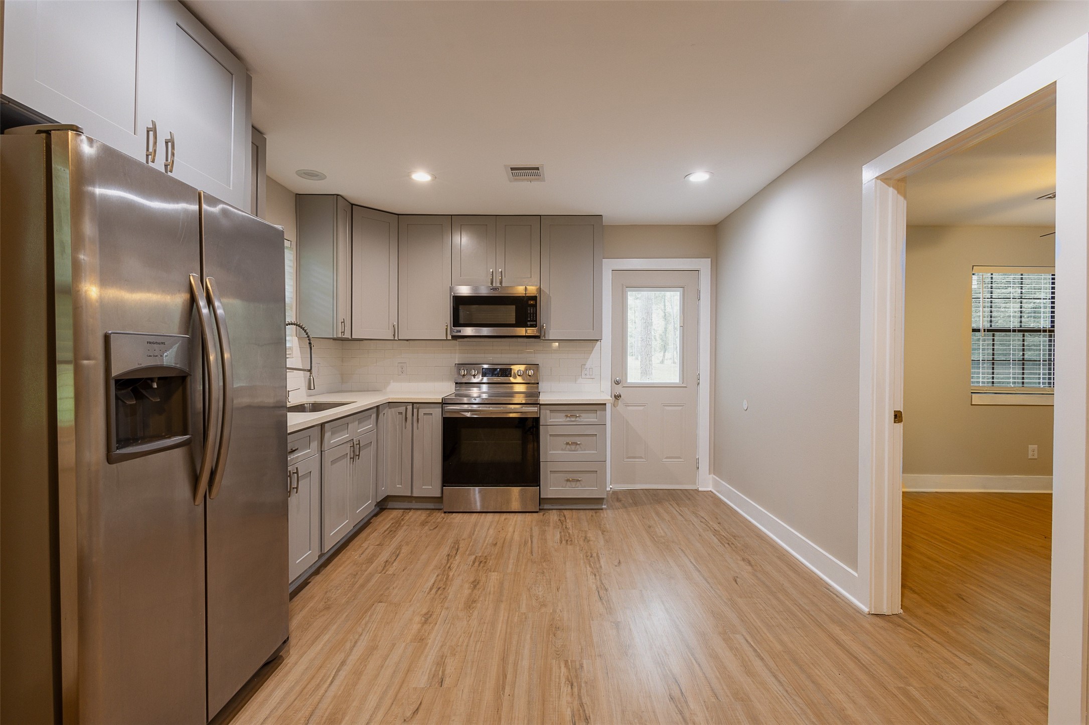 12028 Cedar Lane Conroe, TX 77303 - Photo 7 of 41 a kitchen with stainless steel appliances a refrigerator and a stove top oven
