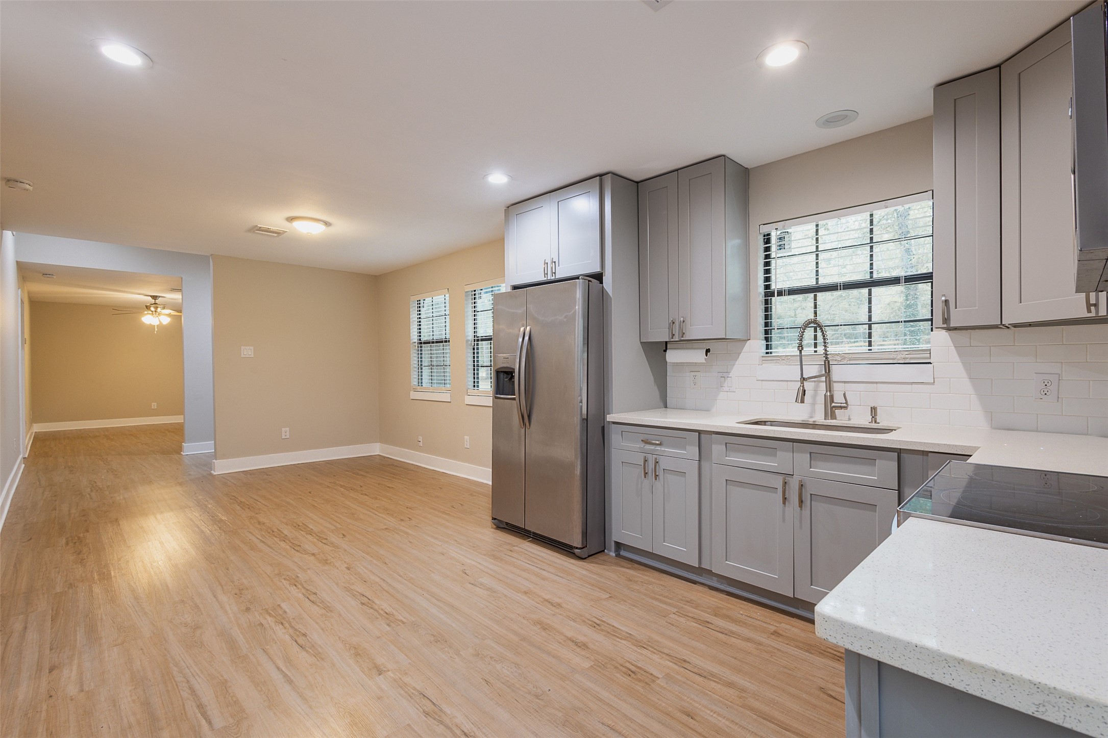 12028 Cedar Lane Conroe, TX 77303 - Photo 8 of 41 a kitchen with stainless steel appliances granite countertop a refrigerator a sink dishwasher and a stove with wooden floor