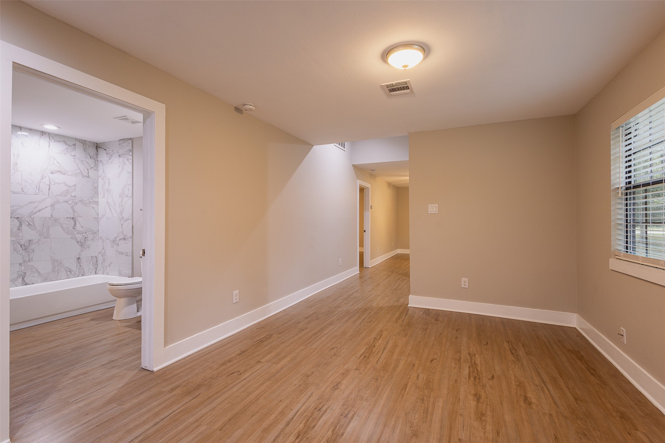 12028 Cedar Lane Conroe, TX 77303 - Photo 10 of 41 an empty room with wooden floor and windows