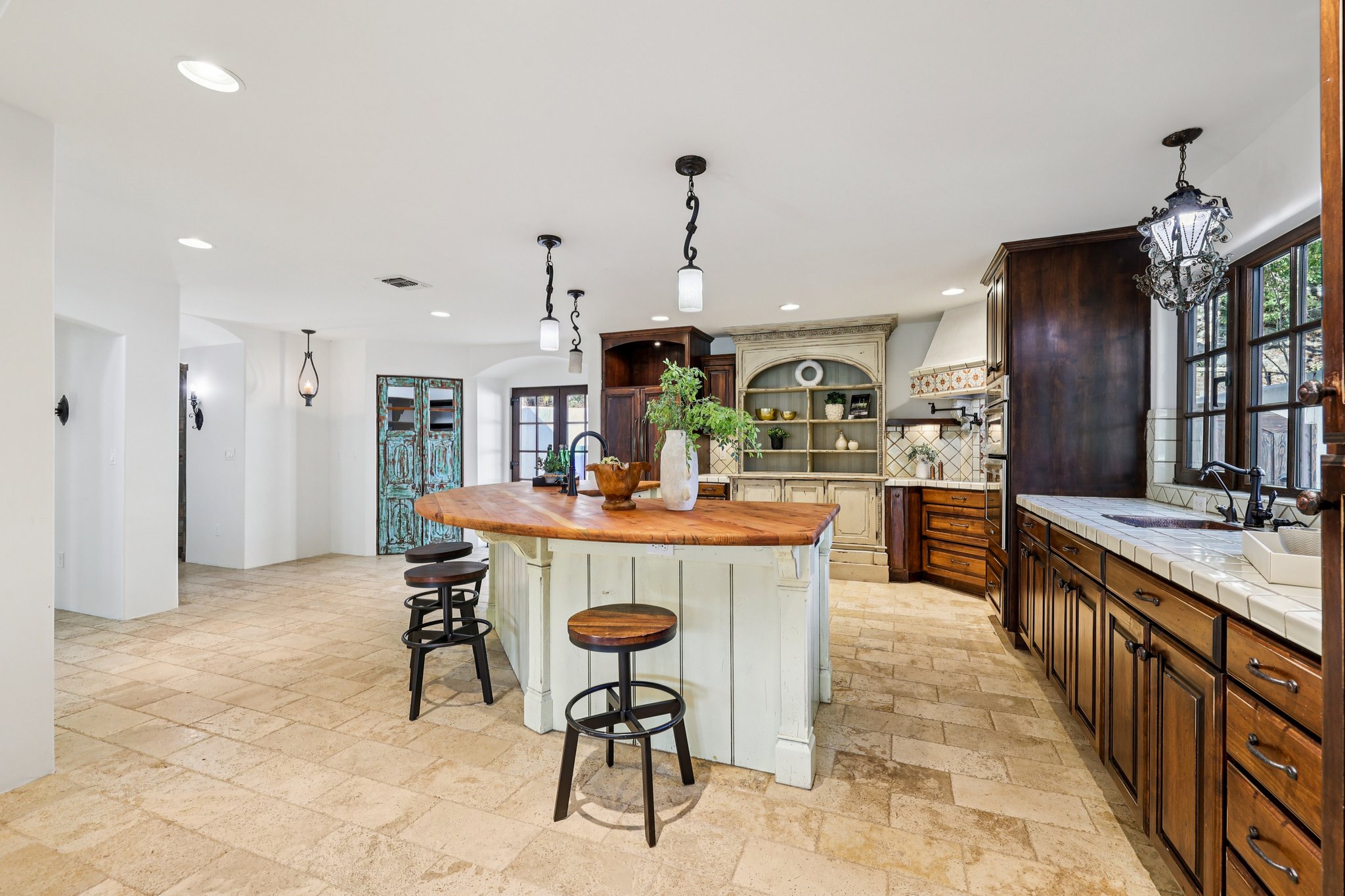 2706 Pearce Road Austin, TX 78730 - Photo 12 of 38 a dining hall with stainless steel appliances kitchen island granite countertop a dining table and chairs