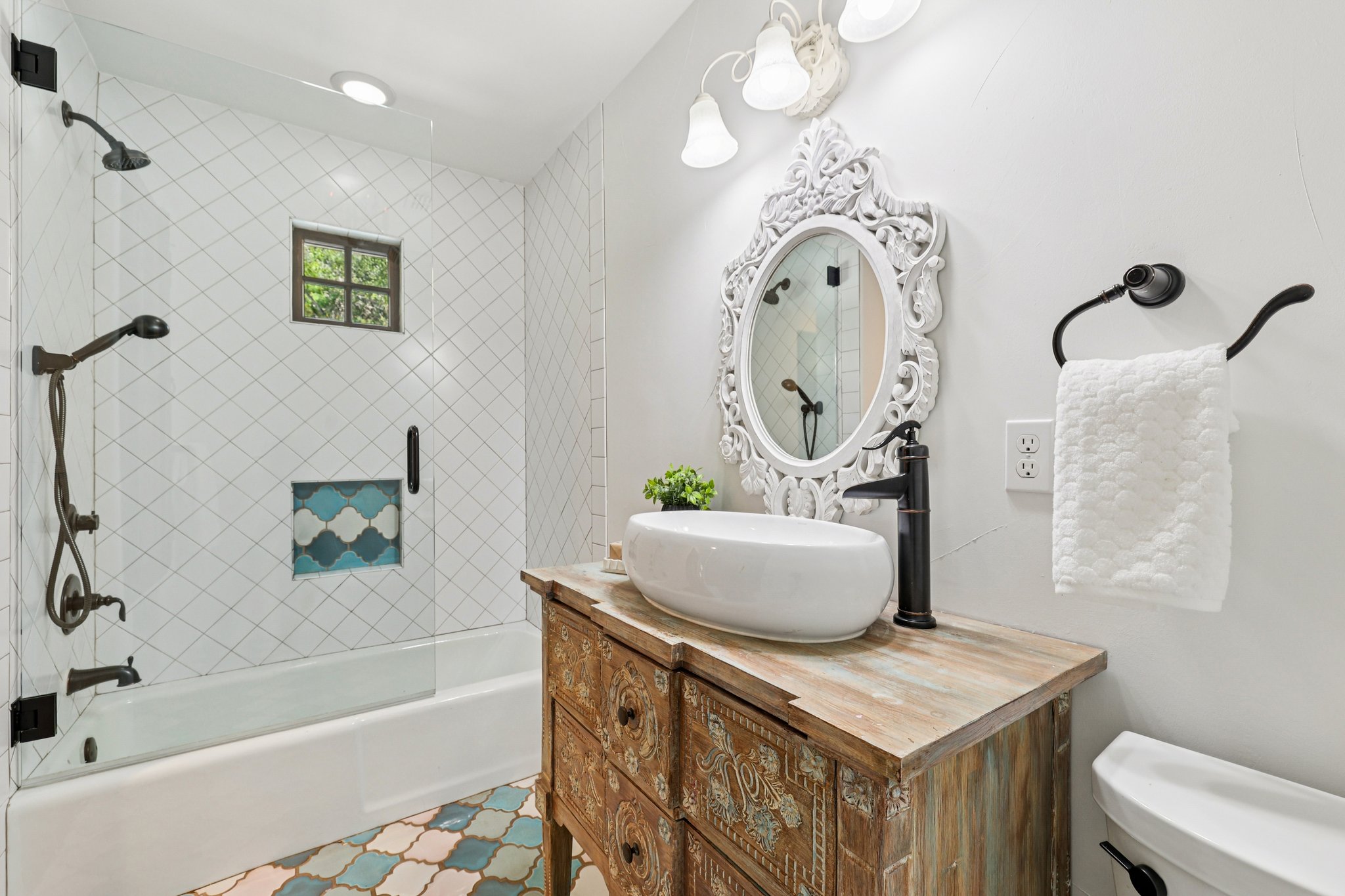 2706 Pearce Road Austin, TX 78730 - Photo 22 of 38 a bathroom with a sink a mirror and a bathtub