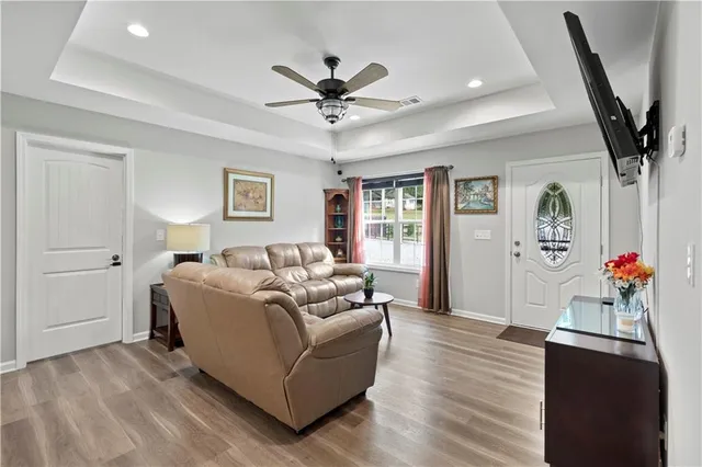 a living room with furniture and a wooden floor