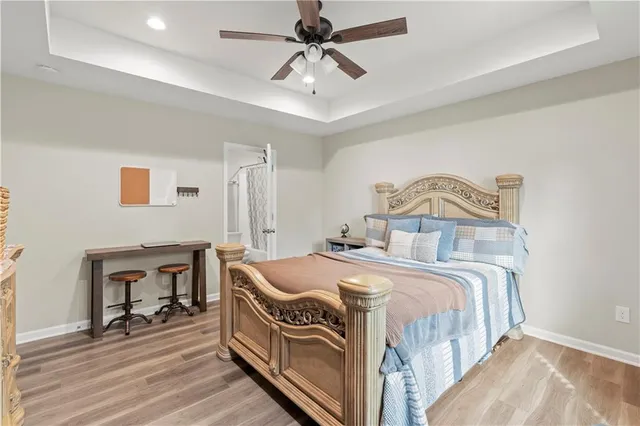 a bedroom with bed and a chandelier
