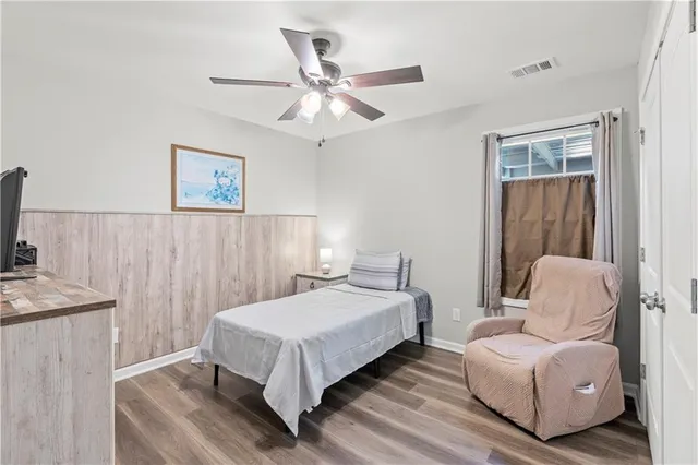 a bedroom with a bed couch and a window