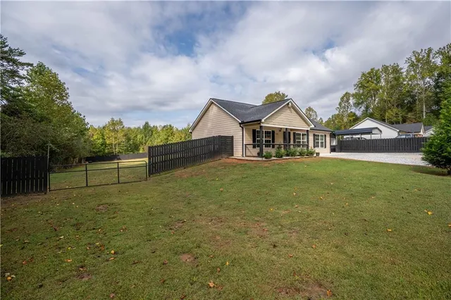a view of a house with a yard and a garden