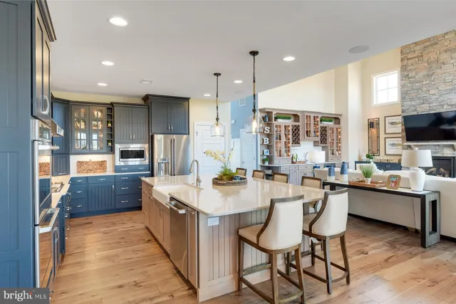 a kitchen with stainless steel appliances kitchen island granite countertop a sink and cabinets