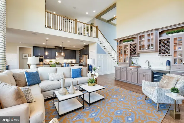 a living room with furniture kitchen view and a large window